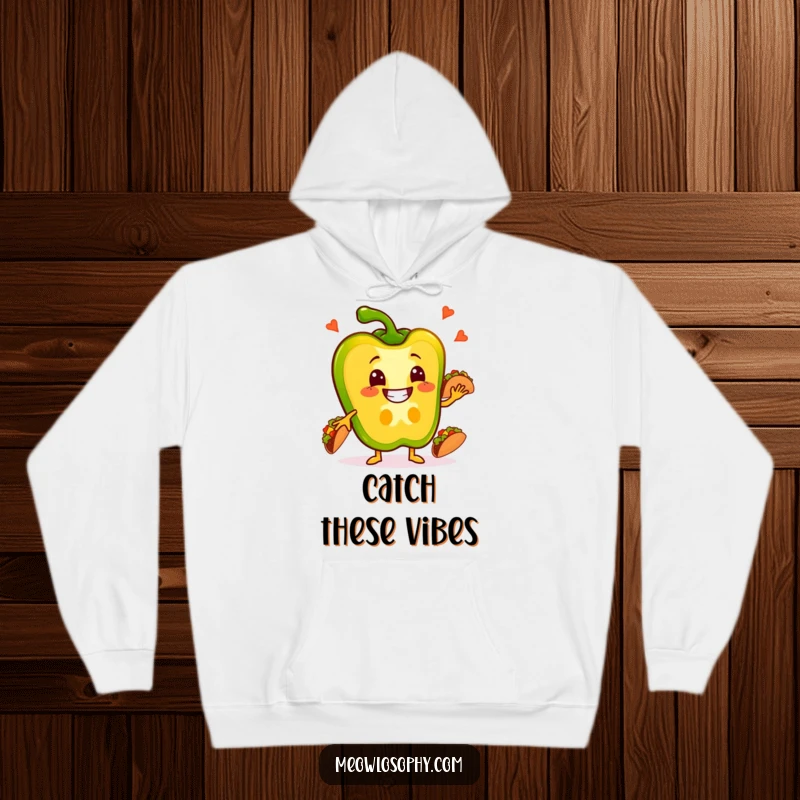Funny Pepper Hoodie with a grinning bell pepper slice juggling small tacos, cozy and festive wear.