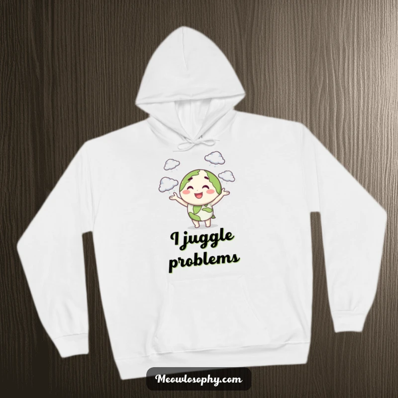 Funny hoodie with a smiling earth character juggling tiny storm clouds with a playful wink, offering cozy, whimsical comfort.