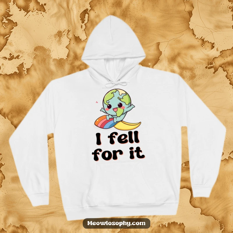 Funny hoodie with a kawaii earth character slipping on a rainbow banana peel, offering cozy comfort and cartoon humor.