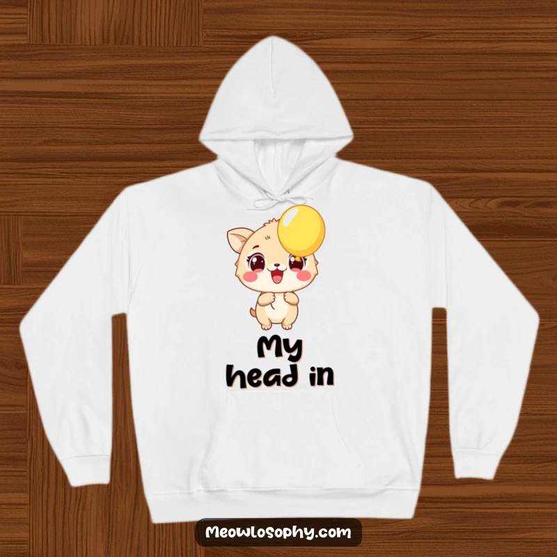 Funny Excited Animal Hoodie showing a character with wide eyes holding a vibrant balloon. A warm, humorous, and joyful piece.