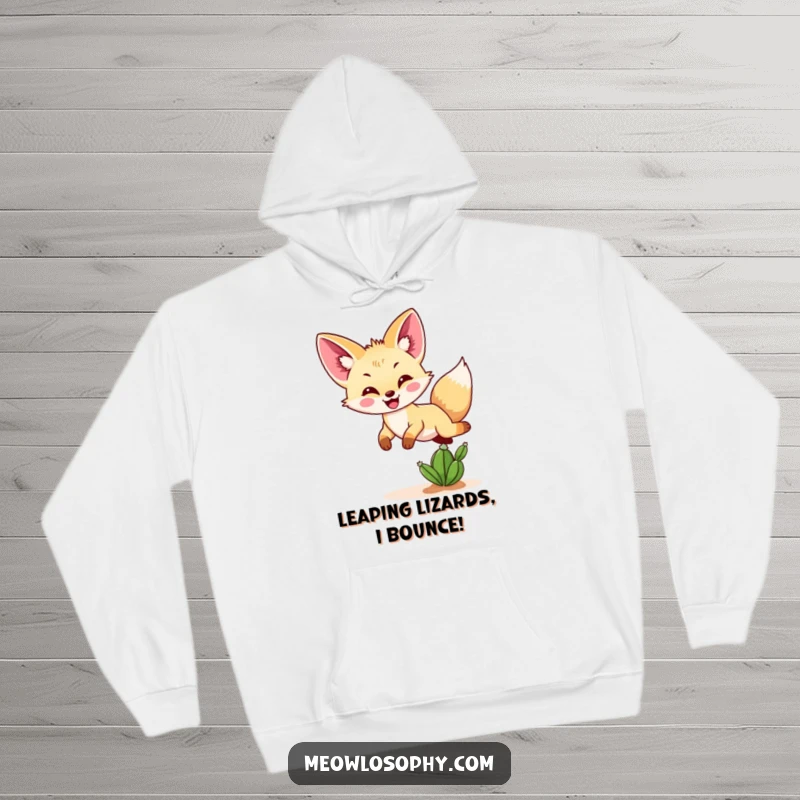 Funny Fennec fox hoodie showcasing a cheerful fennec fox bouncing exuberantly over a tiny cactus, perfect for desert lovers.