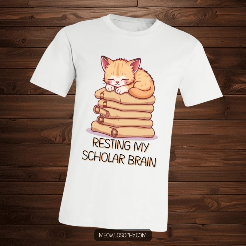 Funny sleepy kitten t-shirt, showcasing a cute cat napping soundly on a pile of ancient scrolls, the epitome of cozy.