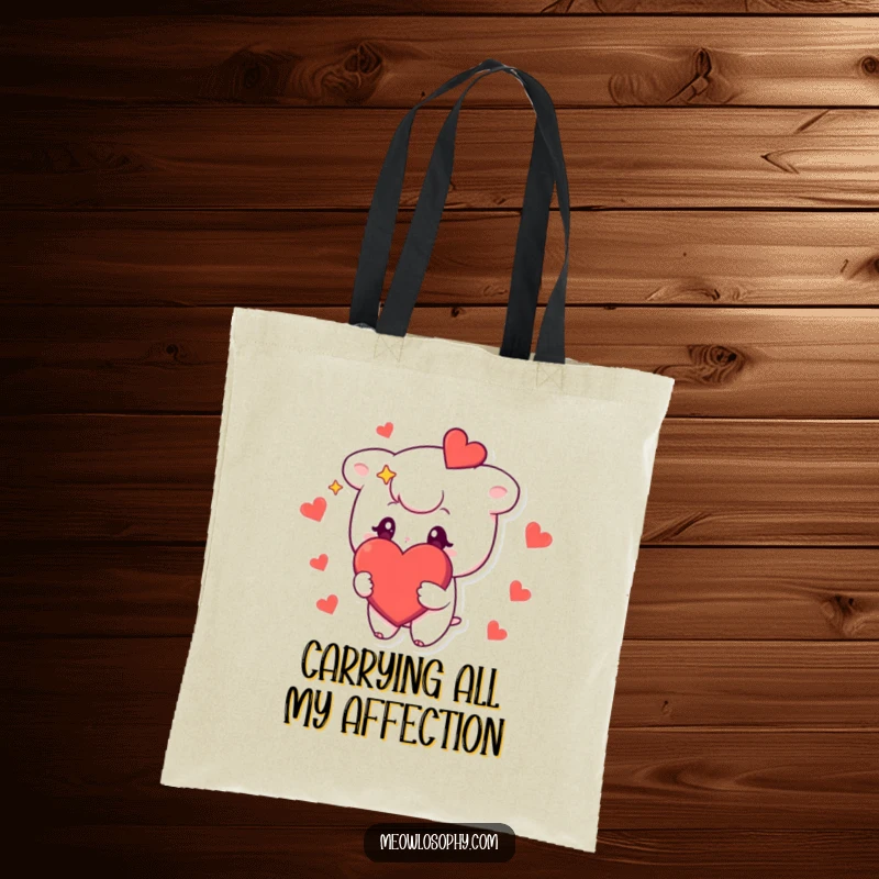 Funny tote bag featuring a cute character with stars in its eyes, holding a large, red heart, perfect for carrying items with love.